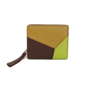Pre-owned LOEWE Puzzle Compact Zip Wallet in Burgundy , Lime, Trio Color Camel, and Bordeaux. Features a snap button closure, billfold, card case, and coin case. Includes Anagram embossed Sahara leather. Bi-fold wallet. C510Z41X01